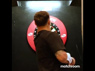 usyk tests his sniper qualities at a game of darts