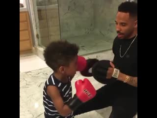 andre ward holding his little son on his paws