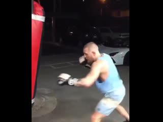 conor mcgregor works in his garage on a heavy bag