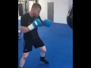 canelo alvarez works on the punching bag