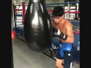 ryan garcia practicing a power punch on a punching bag