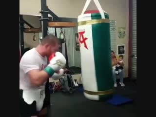 canelo alvarez doing heavy bag strength work while preparing for his fight against rocky felding.