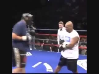 mike tyson helps his opponent stay on his feet