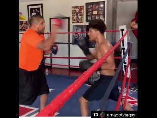 fernando vargas holding his youngest son on his paws.