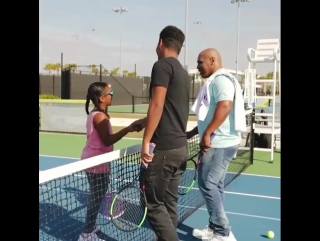 mike tyson plays tennis with his daughter.