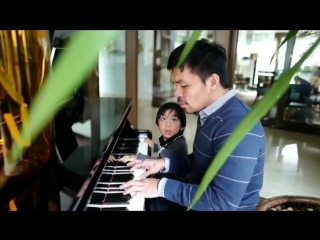 manny pacquiao plays the piano with his youngest son.