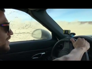 vasily lomachenko drives a porsche on one of the dry lakes in california.