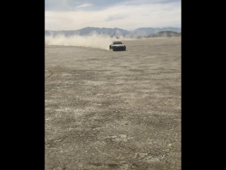 vasily lomachenko drives a porsche on one of the dry lakes in california.