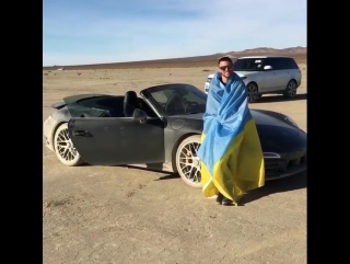 uncle vasya lomachenko drives a porsche across the american desert.